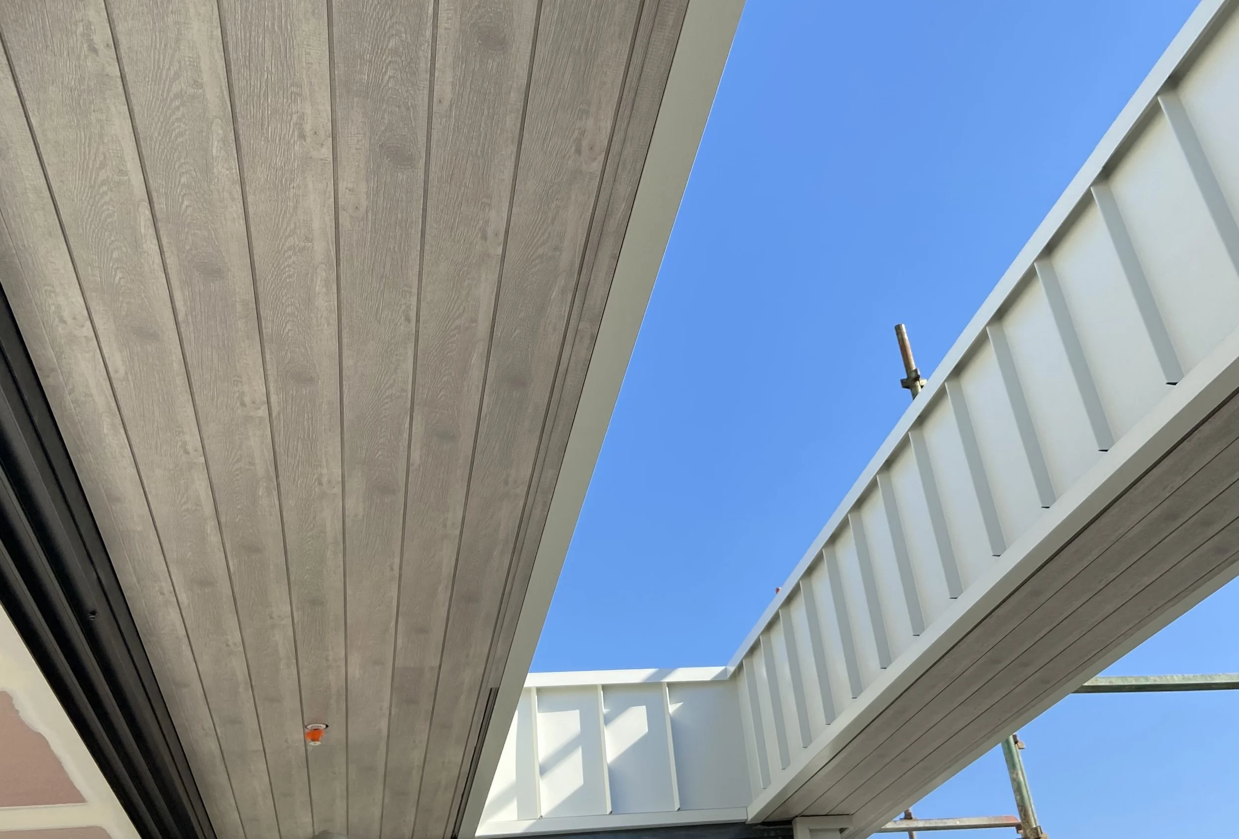 Standing seam cladding and aluminium woodgrain soffit