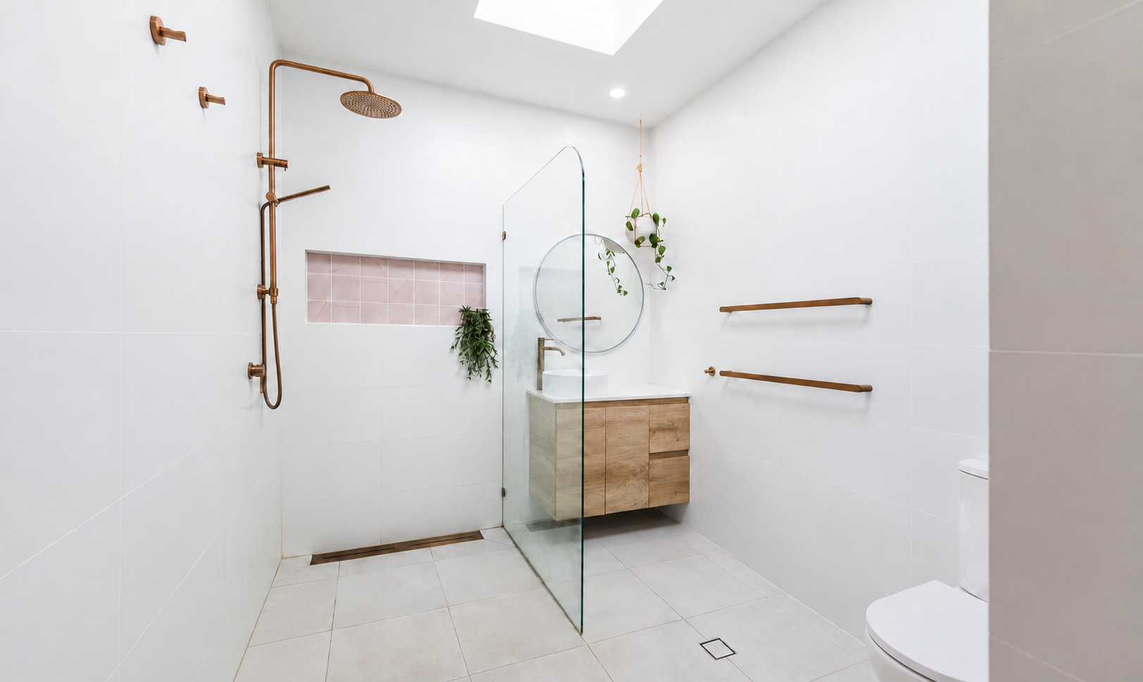 Modern walk-in bathroom with white tiled walls and floor, a wooden vanity with a round mirror, a glass shower enclosure with copper fixtures, potted plants, and wooden towel bars.