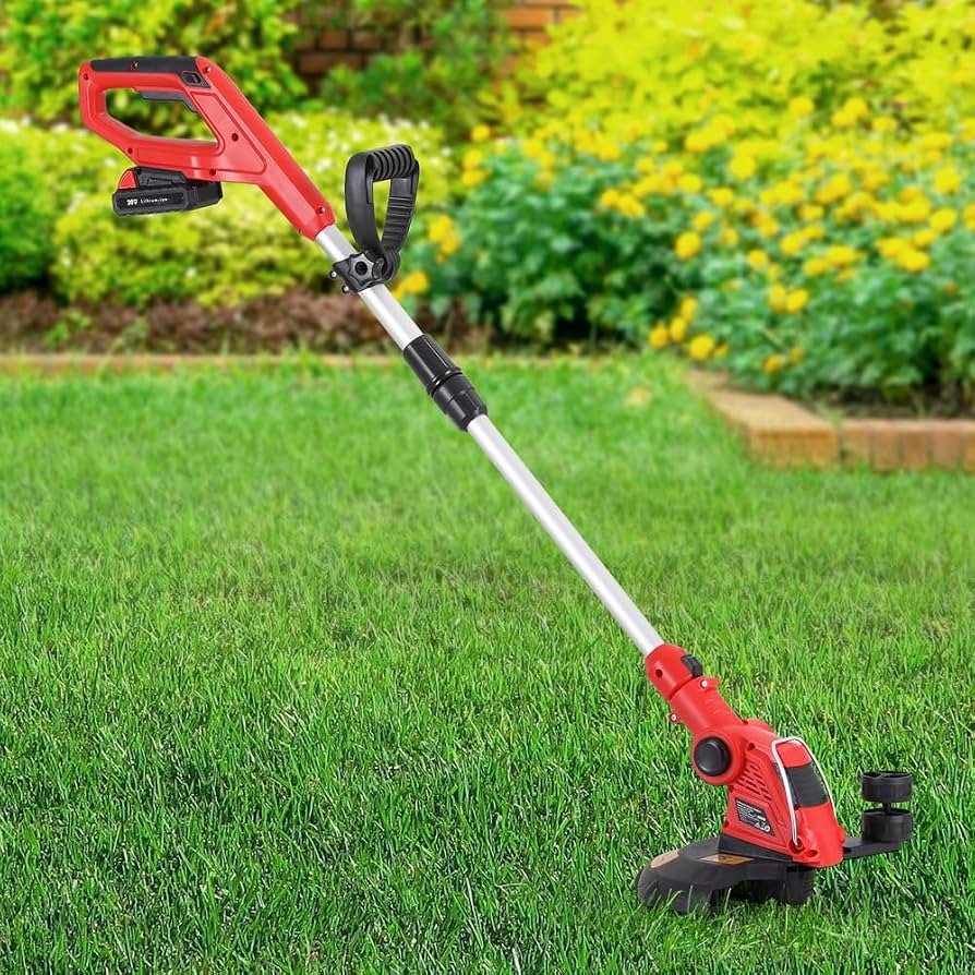 Battery-powered grass trimmer on a lush green lawn in a backyard with flower beds and shrubs in the background.