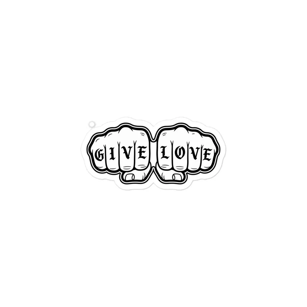 White GIVE LOVE sticker with black tattoo-style fists and lettering across the knuckles