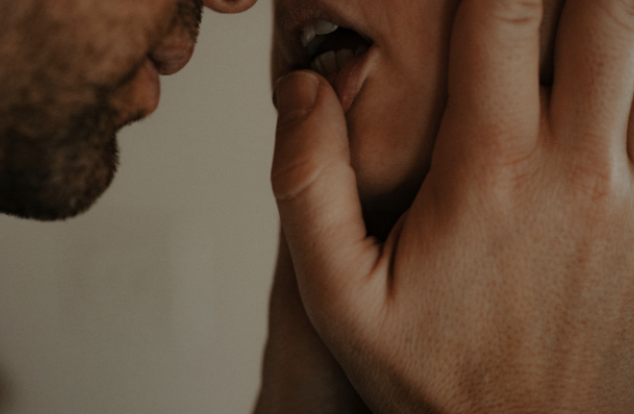 Close-up of a dental professional examining a patient’s teeth and mouth.