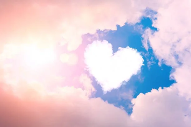 Clouds in the sky with a heart-shaped formation in the center.