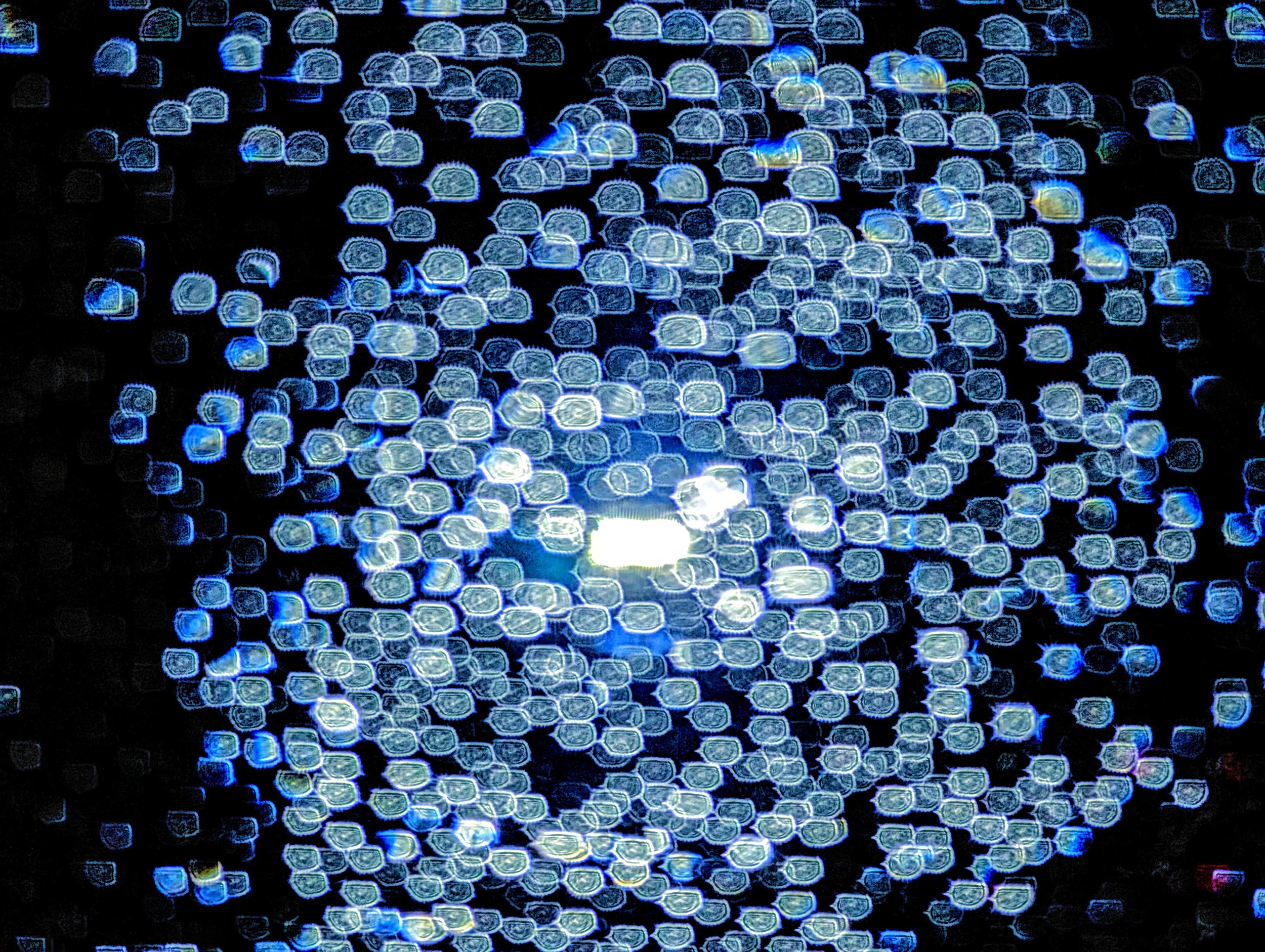 Refractions in Blue (2024). Raindrops and a streetlight, editing to meet the imagination of the moment. Currently on display at the Austin Public Library - Carver Branch.