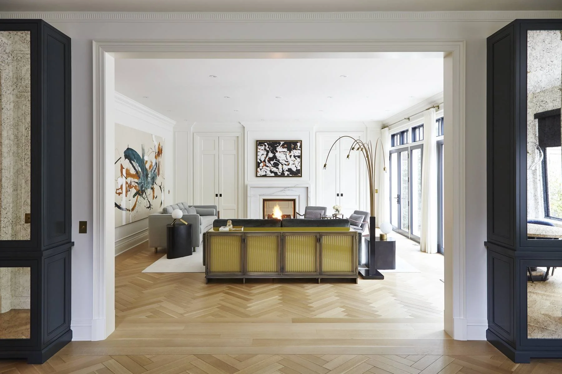 Open living space with fireplace and white panelled millwork