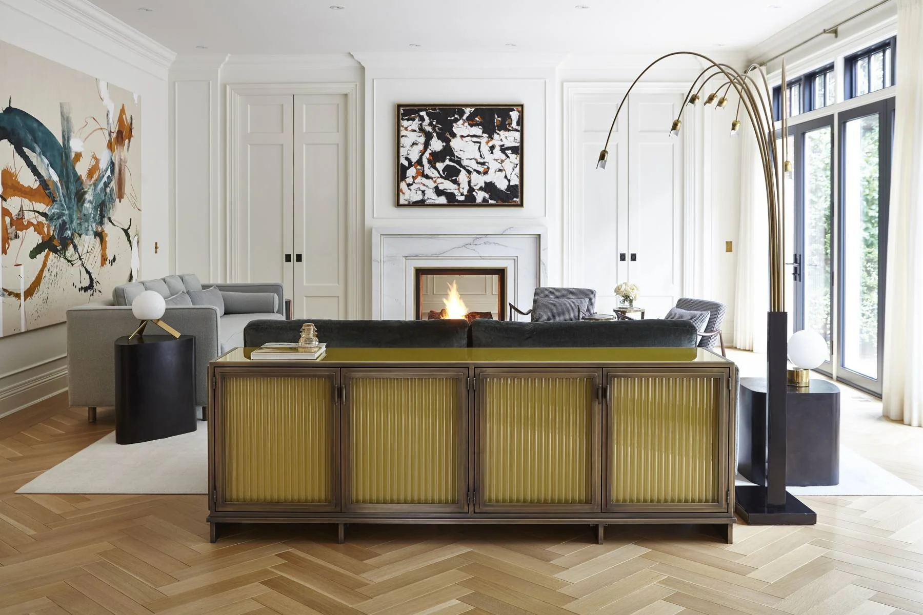 Living room with panelled walls, fireplace and herringbone floor
