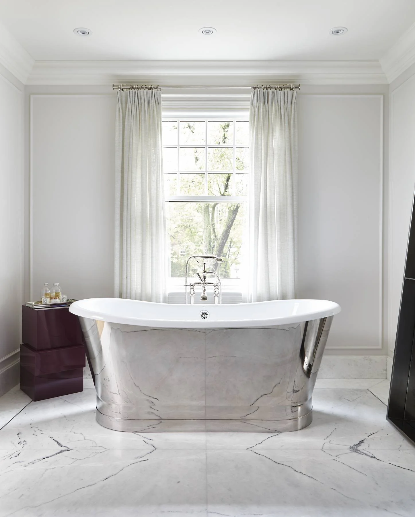 Bathroom with freestanding nickel tub and marble floor
