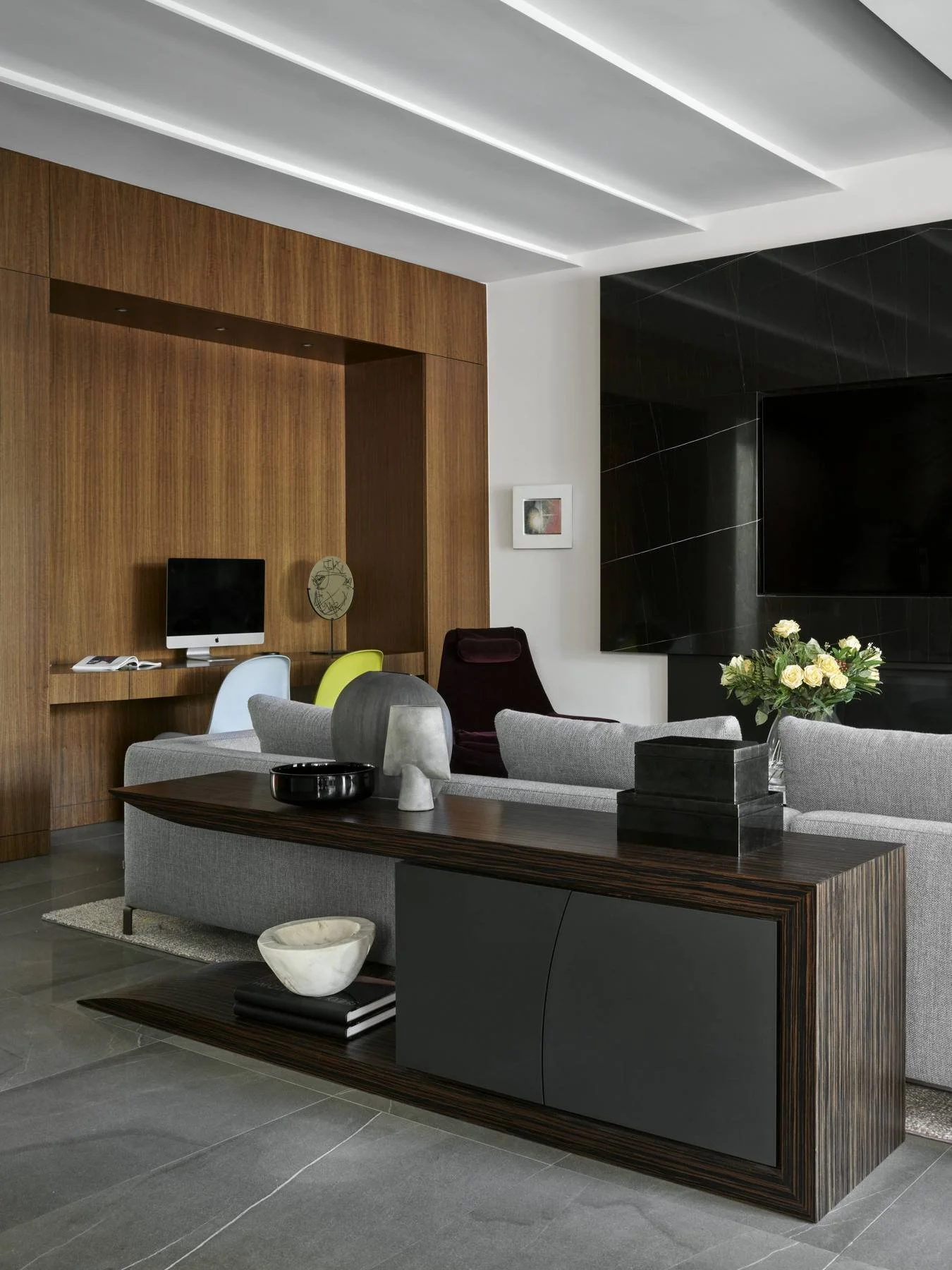 Family room with walnut-panelled media wall and low sectional