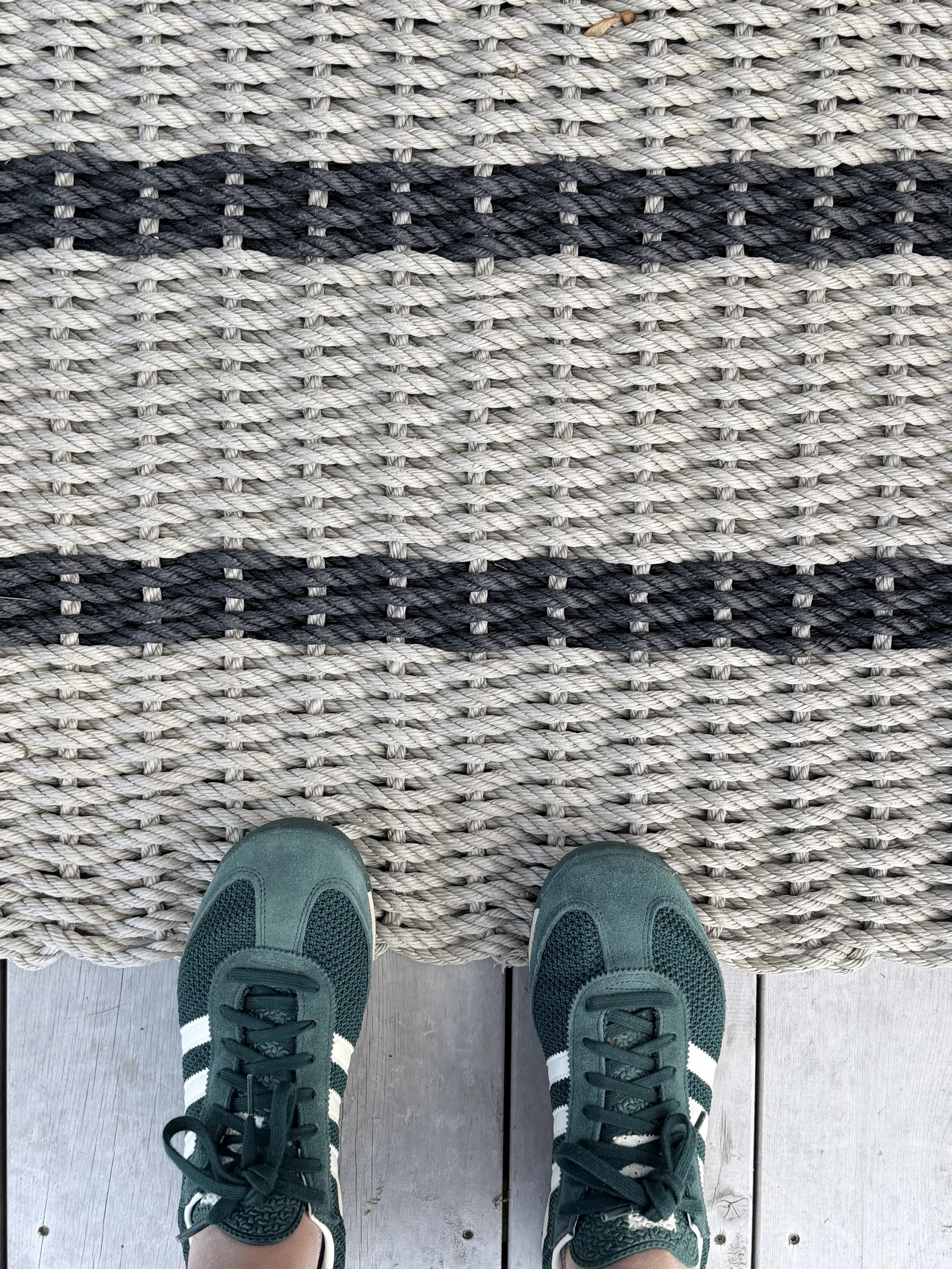 Green sneakers and welcome mat 