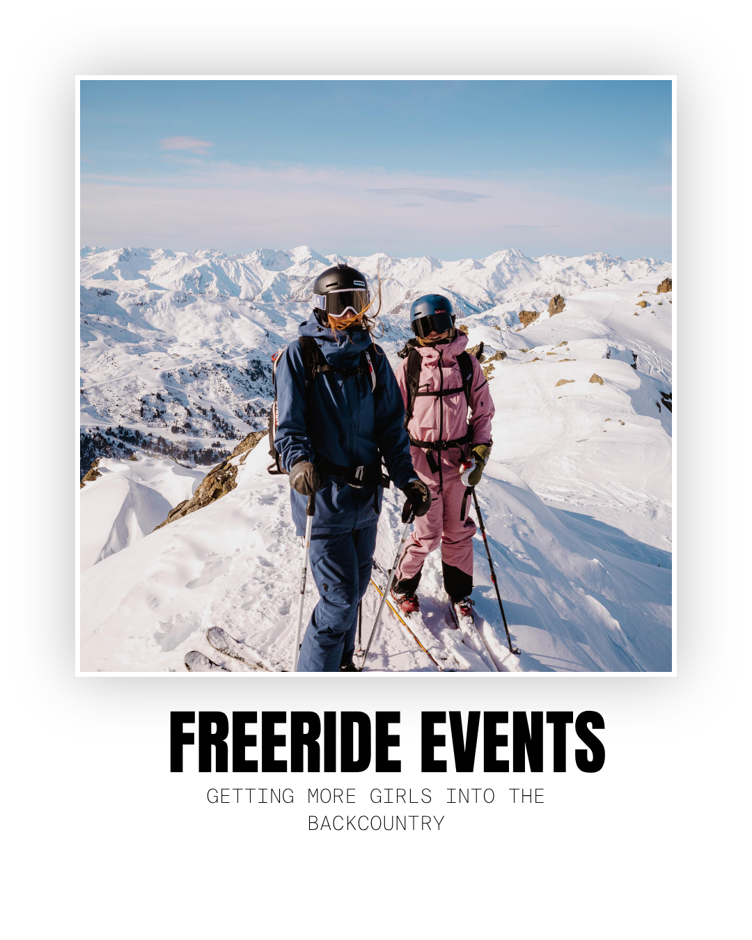 Two skiers in winter gear standing on snowy mountain with a backdrop of snow-covered peaks and blue sky.