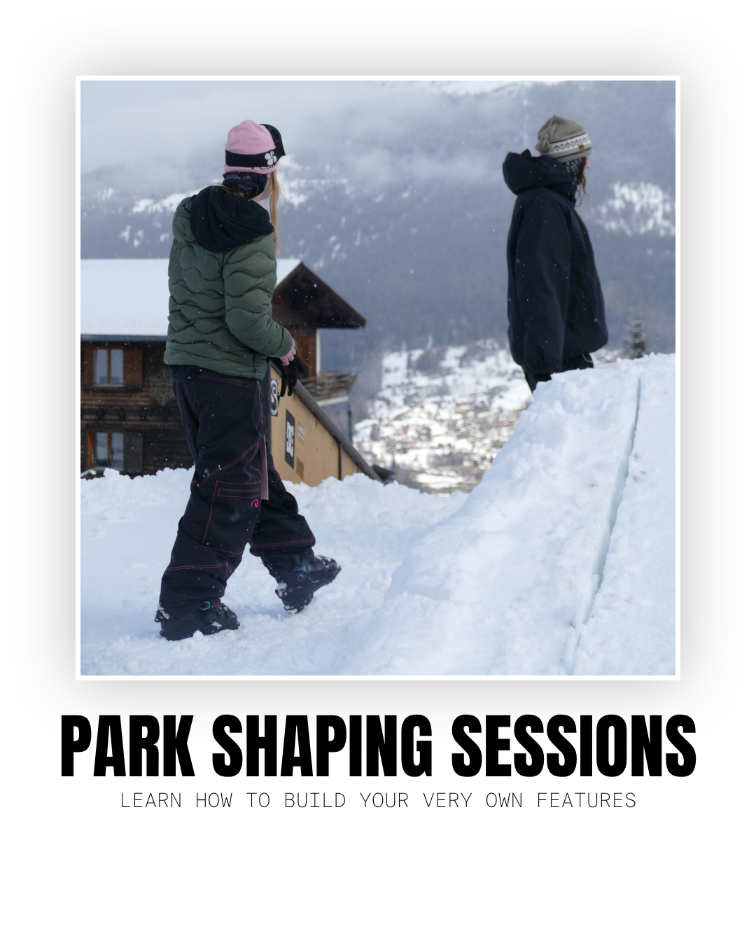 Two children dressed in winter clothing standing in the snow near a snow ramp, with a mountain and cloudy sky in the background.