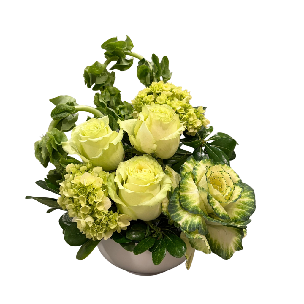 Yellow flower arrangement with roses, hydrangeas, and variegated leaves in a white vase.