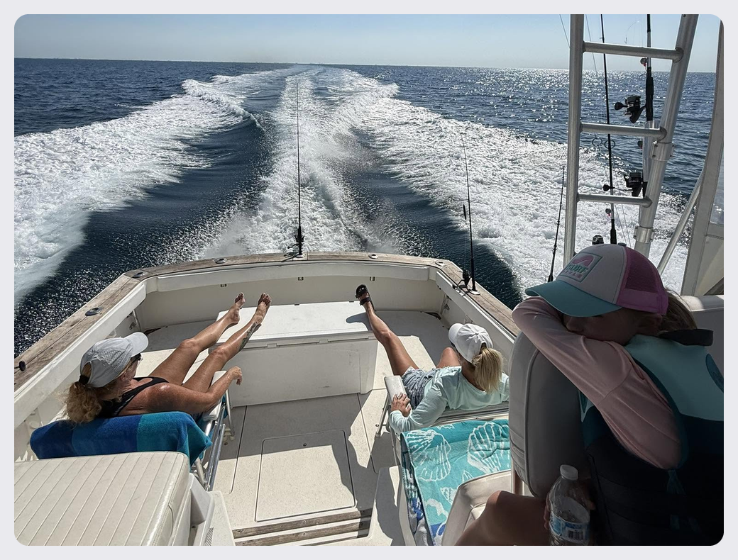 Guests relaxing on the deck of Southern Grin while cruising across the water.