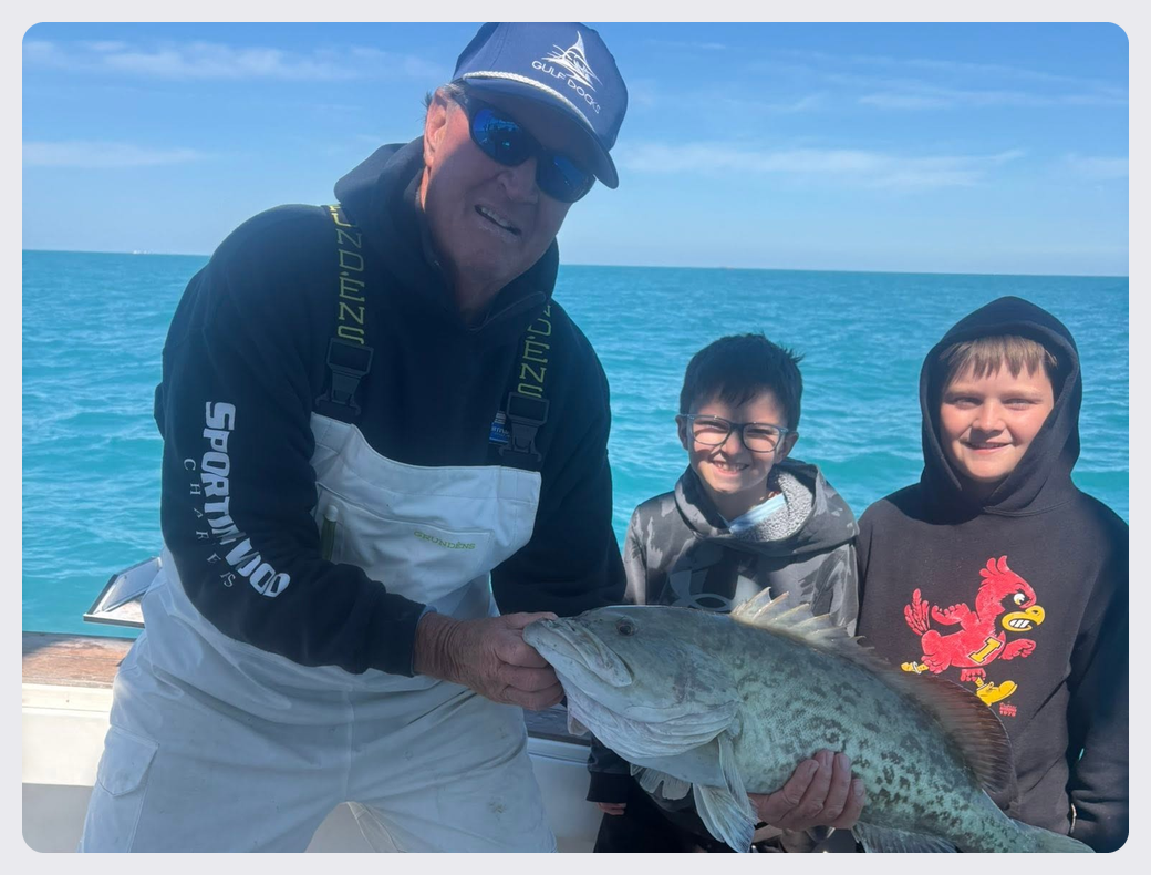 Family posing with their catches aboard the Southern Grin fishing charter boat.