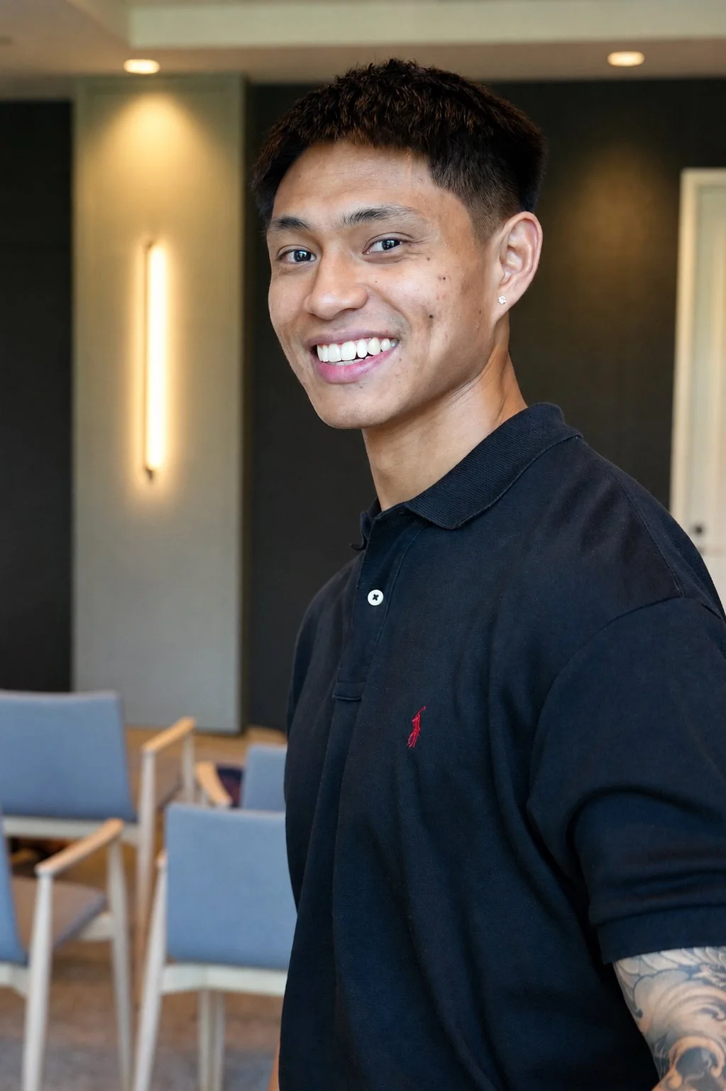 Portrait of Chris Punsalan, author of When Giving Gives Back and former family caregiver, smiling in a black polo shirt.