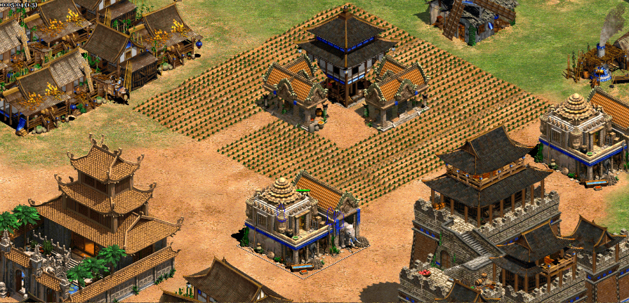 A detailed screenshot of a medieval city layout from a strategy game, showing traditional Asian-style buildings, farm fields, and a fortified structure in the center.