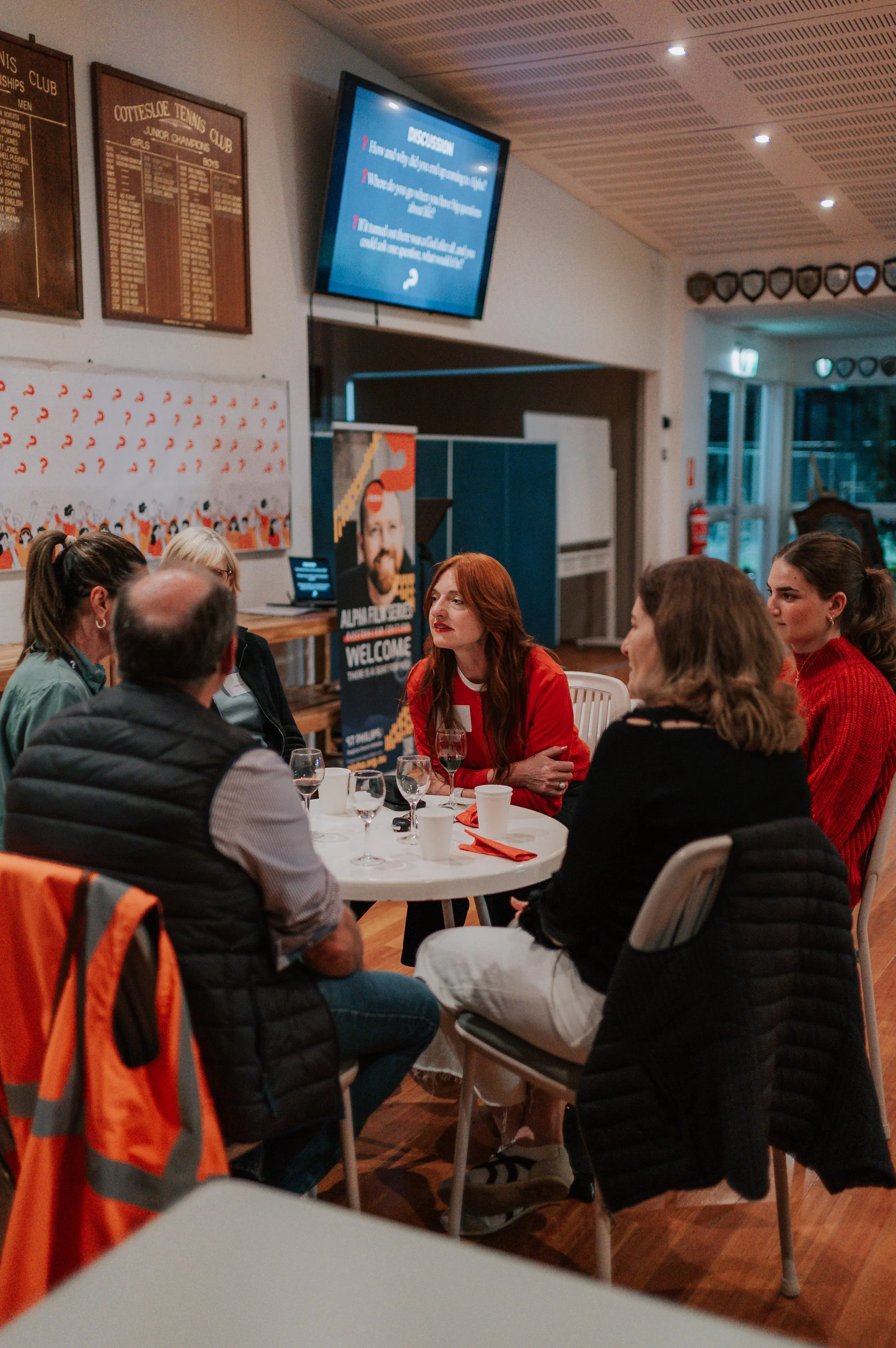 People sharing conversation around a table at the St Philips Alpha launch.