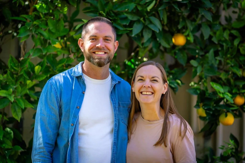 Kieran Carr and a companion standing together in a citrus garden.