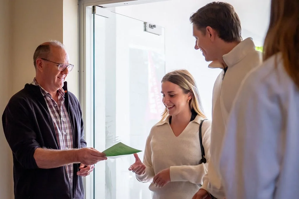 A St Philips welcomer offering a leaflet to visitors.