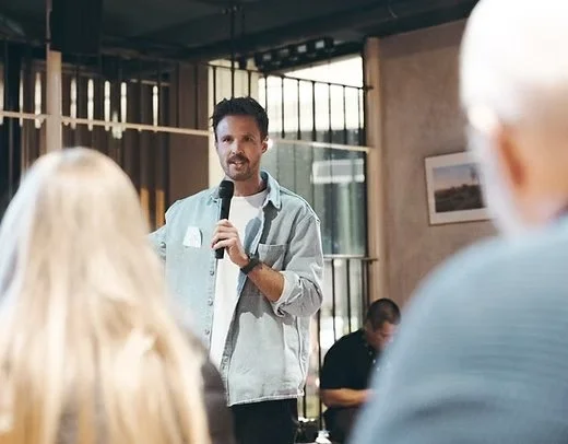 A speaker talking with people at an Alpha gathering.