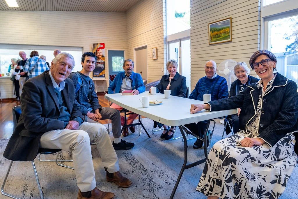 People sharing a table and conversation at St Philip’s.