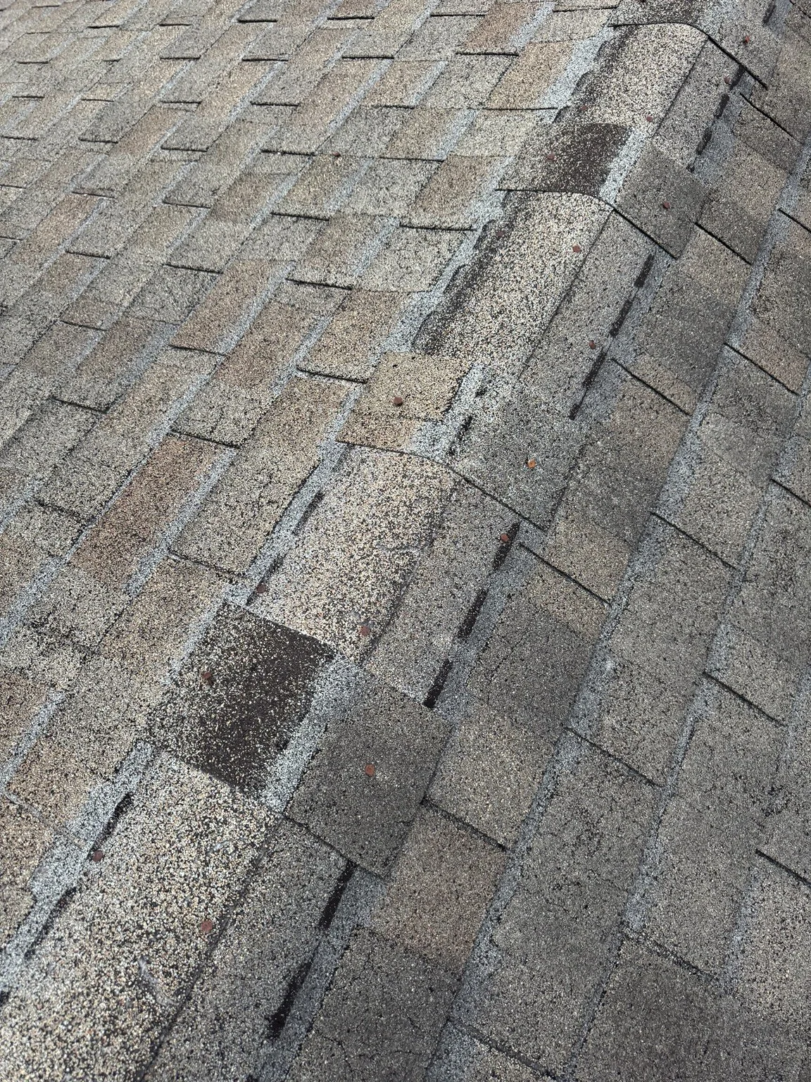 Exposed and backed-out nails deserve attention. Raised or exposed fasteners are worth checking during a roof inspection.
