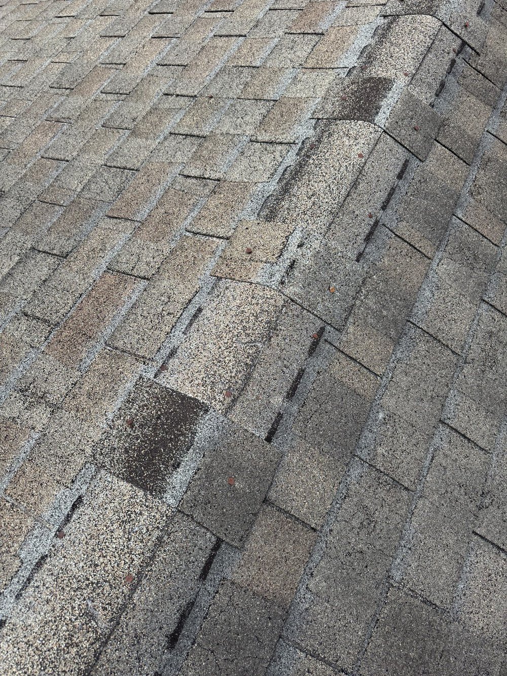 Exposed and backed-out nails deserve attention. Raised or exposed fasteners are worth checking during a roof inspection.