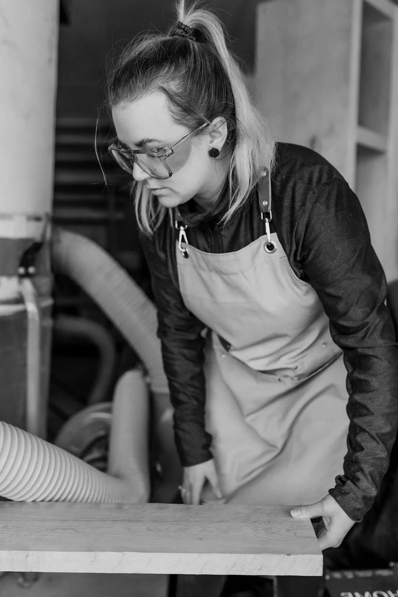 wood artist pushing hardwood through planer