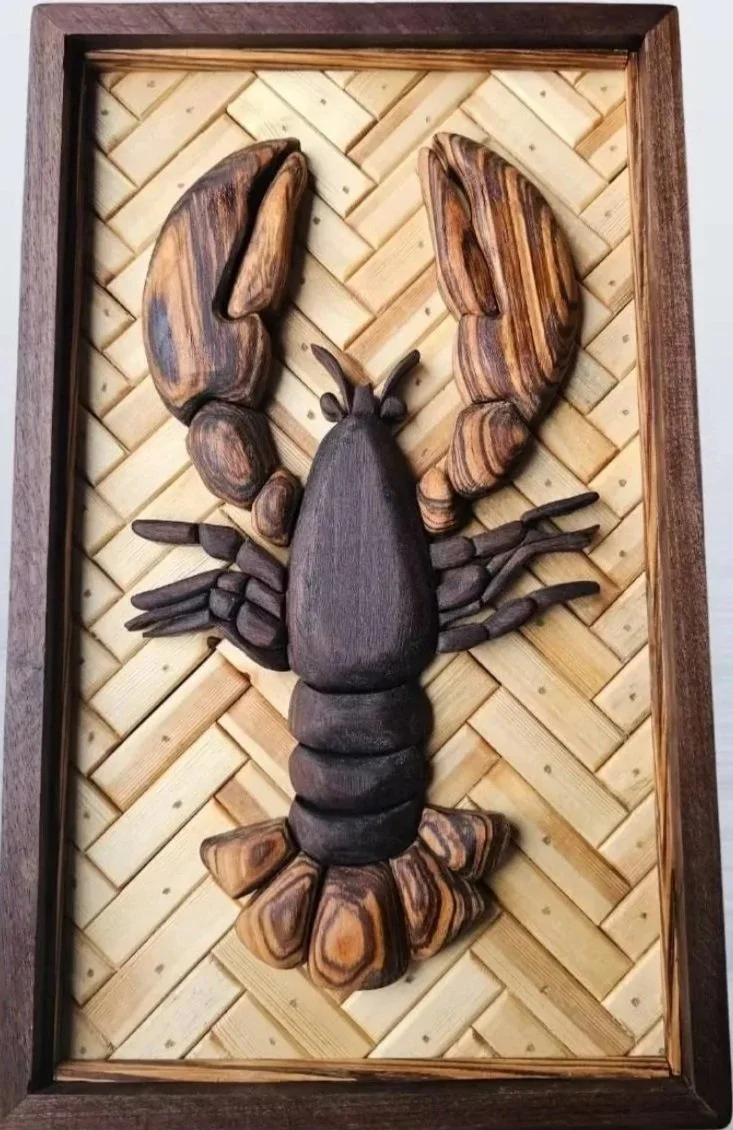 Wooden sculpture of a lobster on a woven wooden background in a frame.