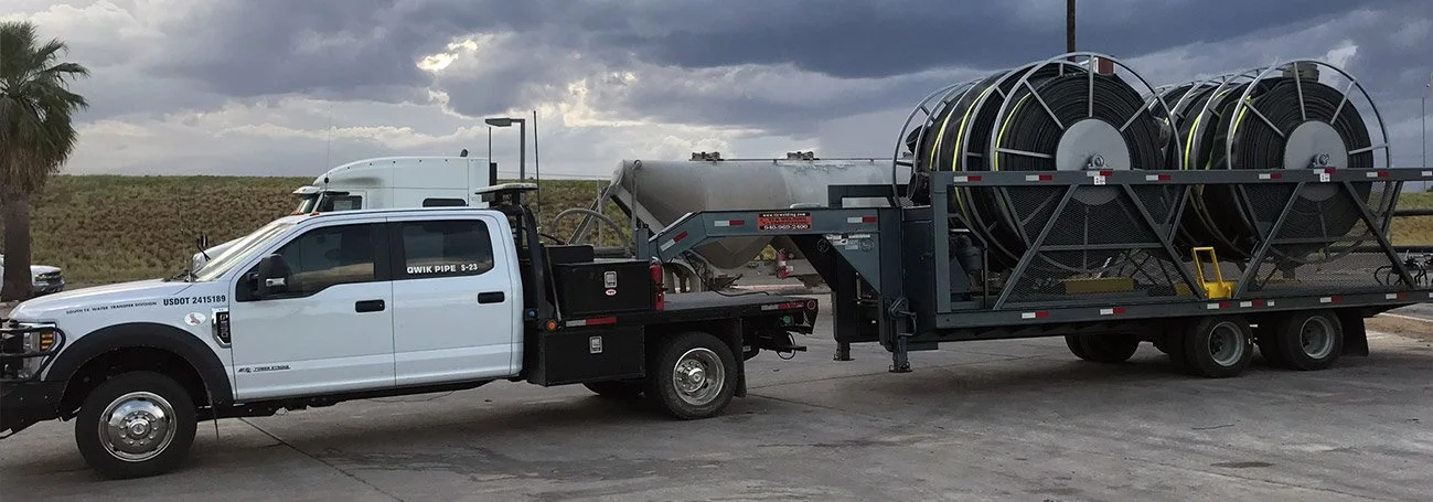 Qwik Pipe service truck with a gooseneck trailer carrying four lay flat hose spools