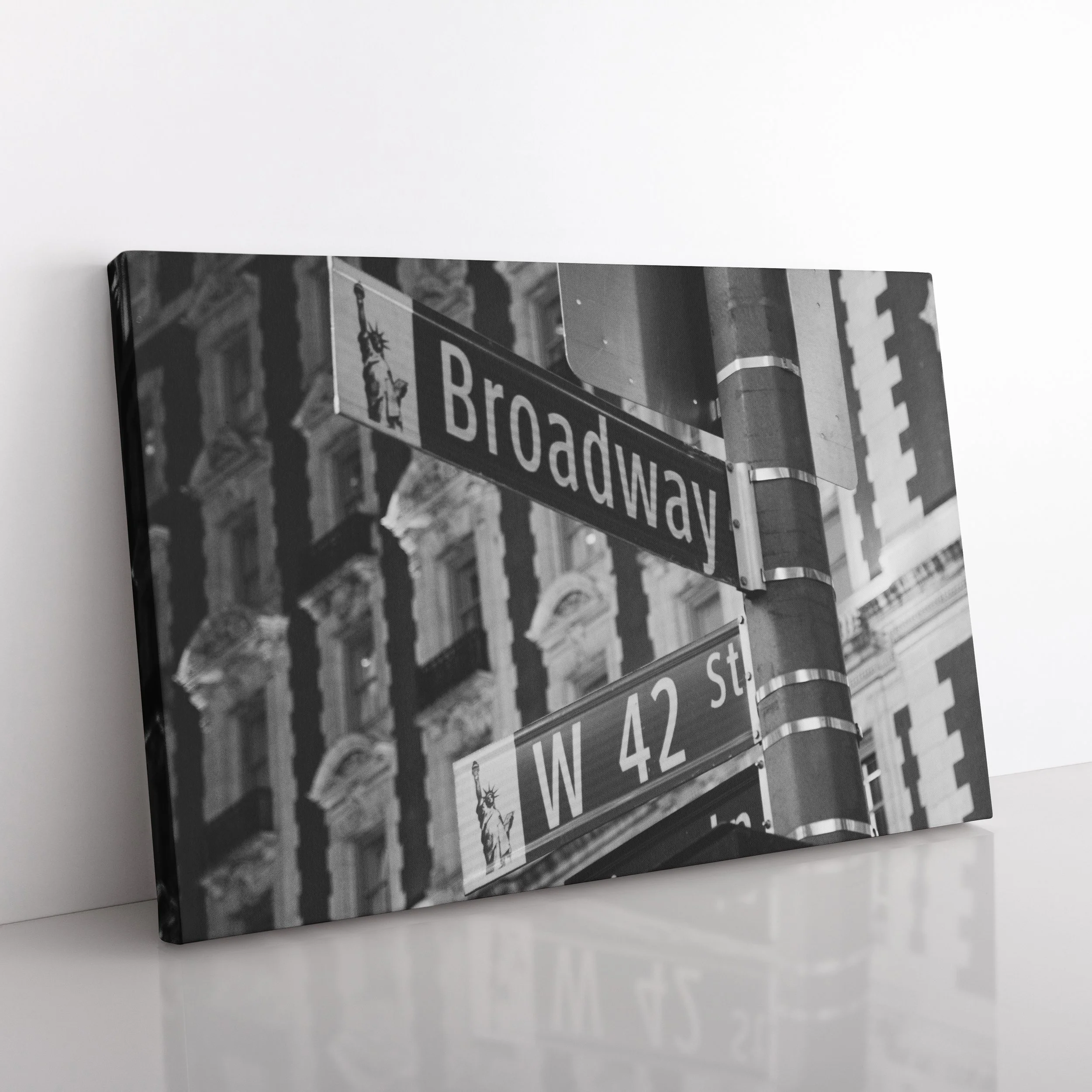 Angled side view of a black and white Broadway street sign canvas print resting on a white surface, ideal for theatre lover gifts