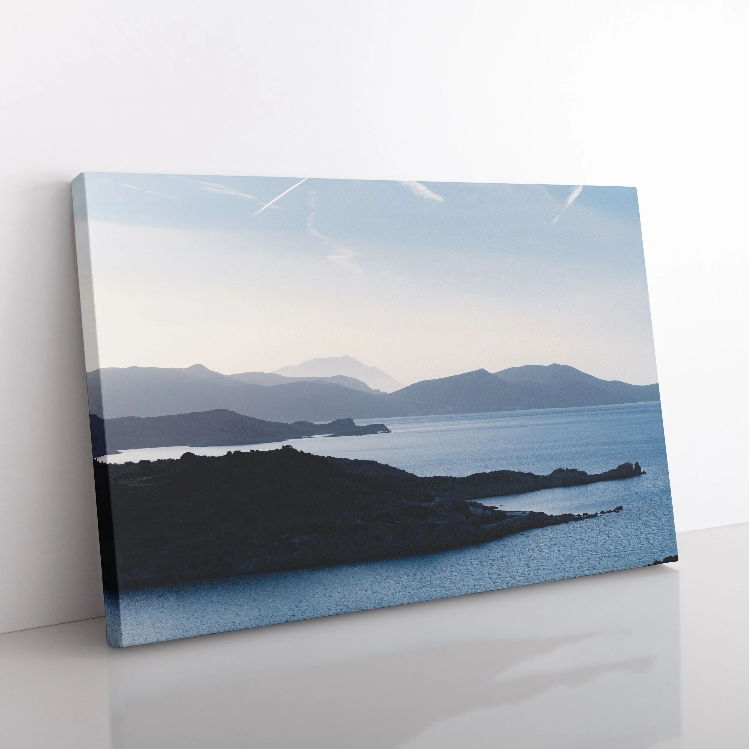 Gallery-wrapped canvas print of a serene landscape in Milos, Greece showing layered blue mountains and sea.