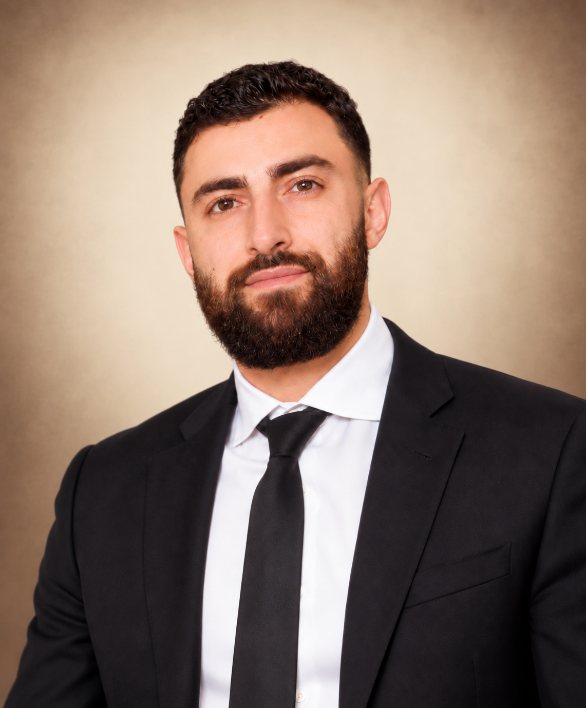 Nick Nshanyan, founder of Nshanyan Enterprises, against a warm cream background.