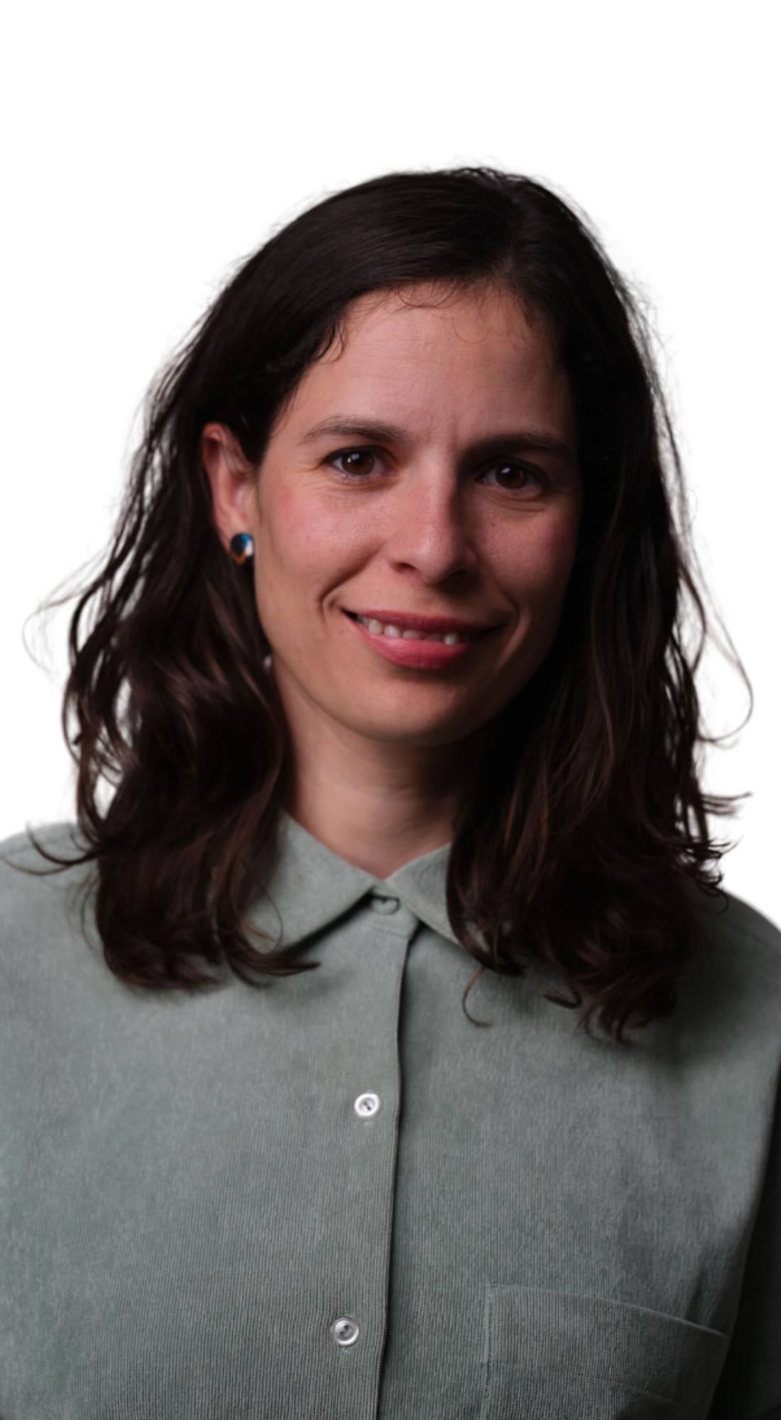 A woman with shoulder-length brown hair wearing a light green button-up shirt against a white background.