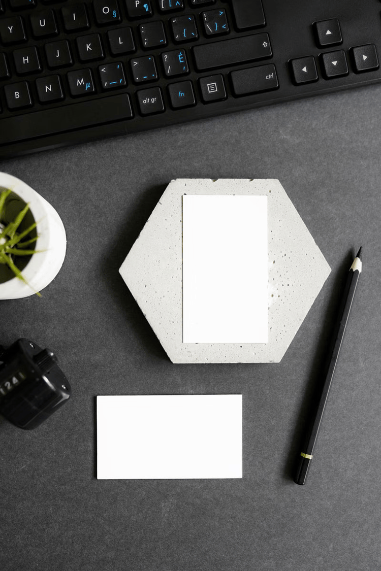 Business cards and stationery on a dark desk