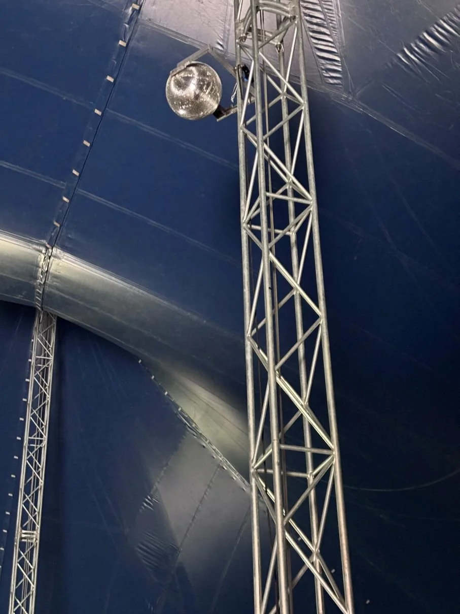 Metal truss and rigging supporting an event installation