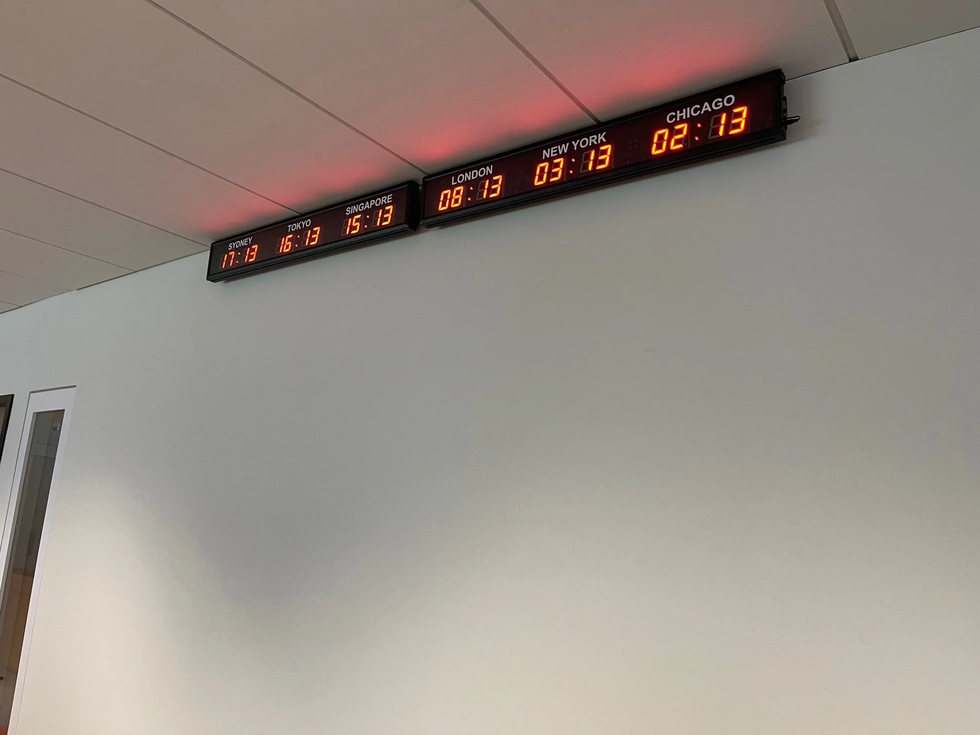 Digital clock display showing the times in different cities: Sydney at 17:13, Tokyo at 16:13, Singapore at 15:13, London at 08:13, New York at 03:13, and Chicago at 02:13.