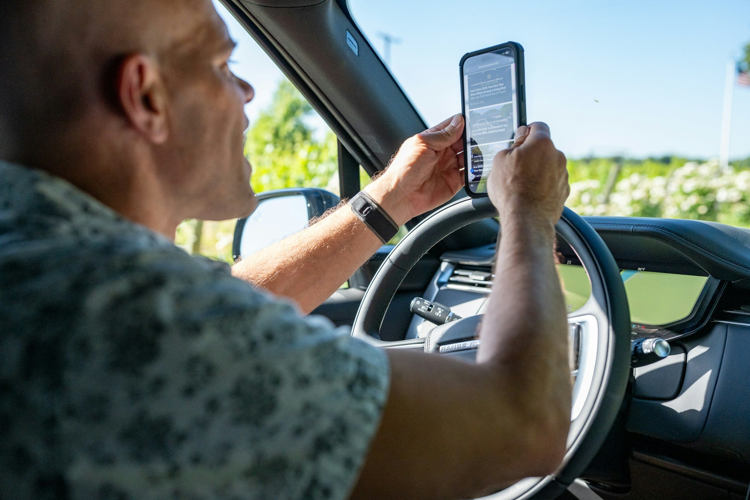Truck driver checking a job match on his phone in the cab