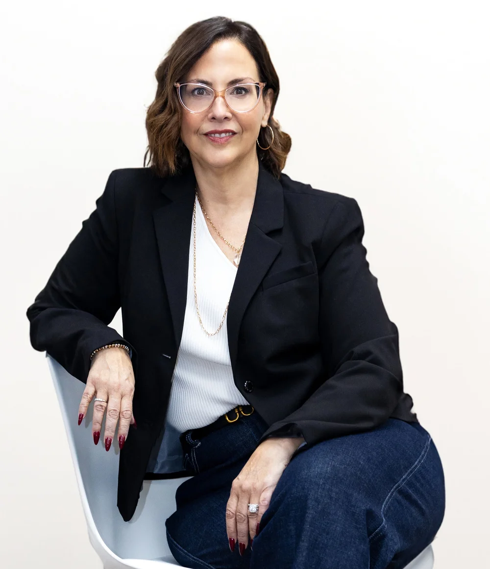 Jan Southern seated in a navy suit