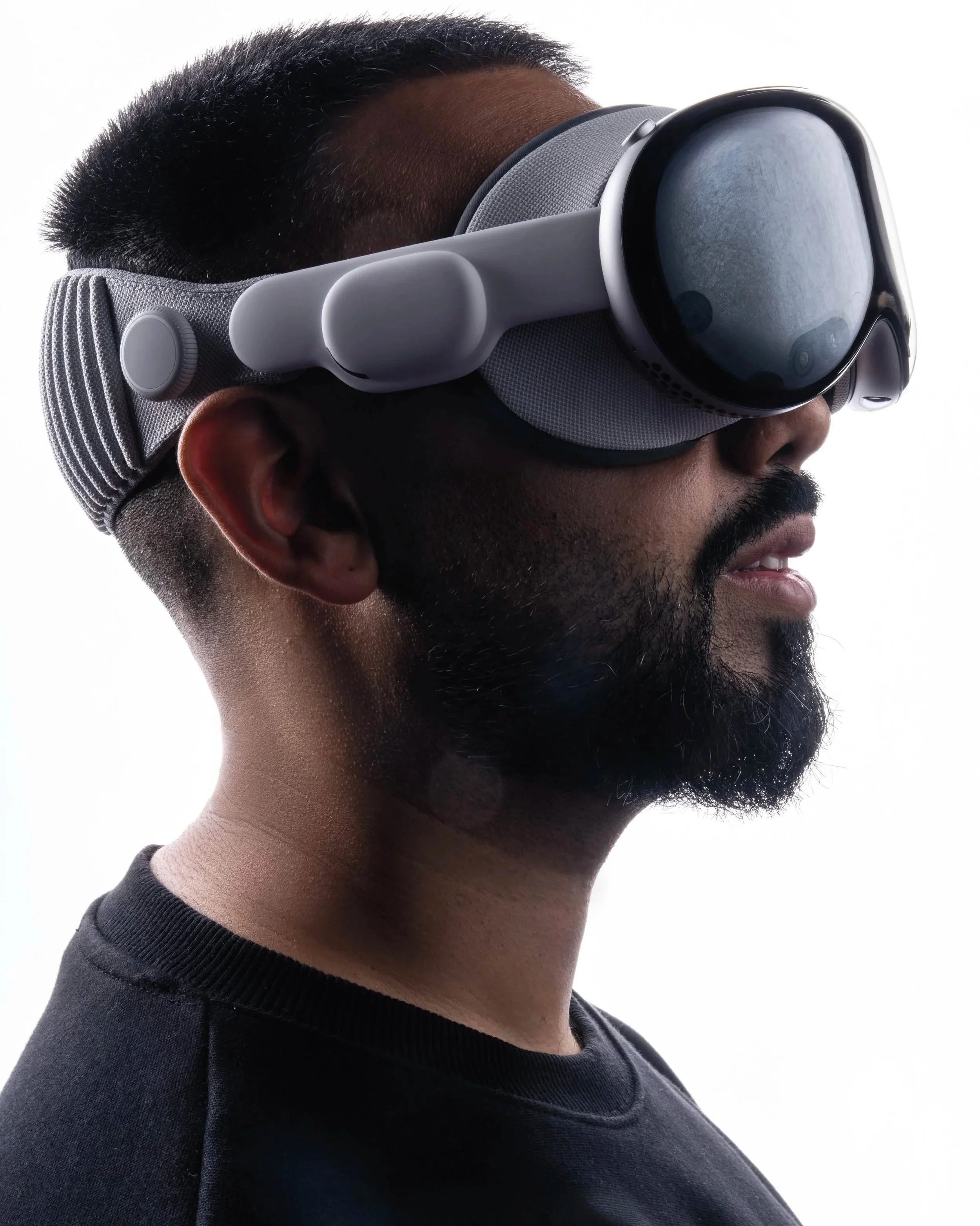 Headset / side-profile image
    EMKWAN wearing a mixed-reality headset while exploring immersive technology.
