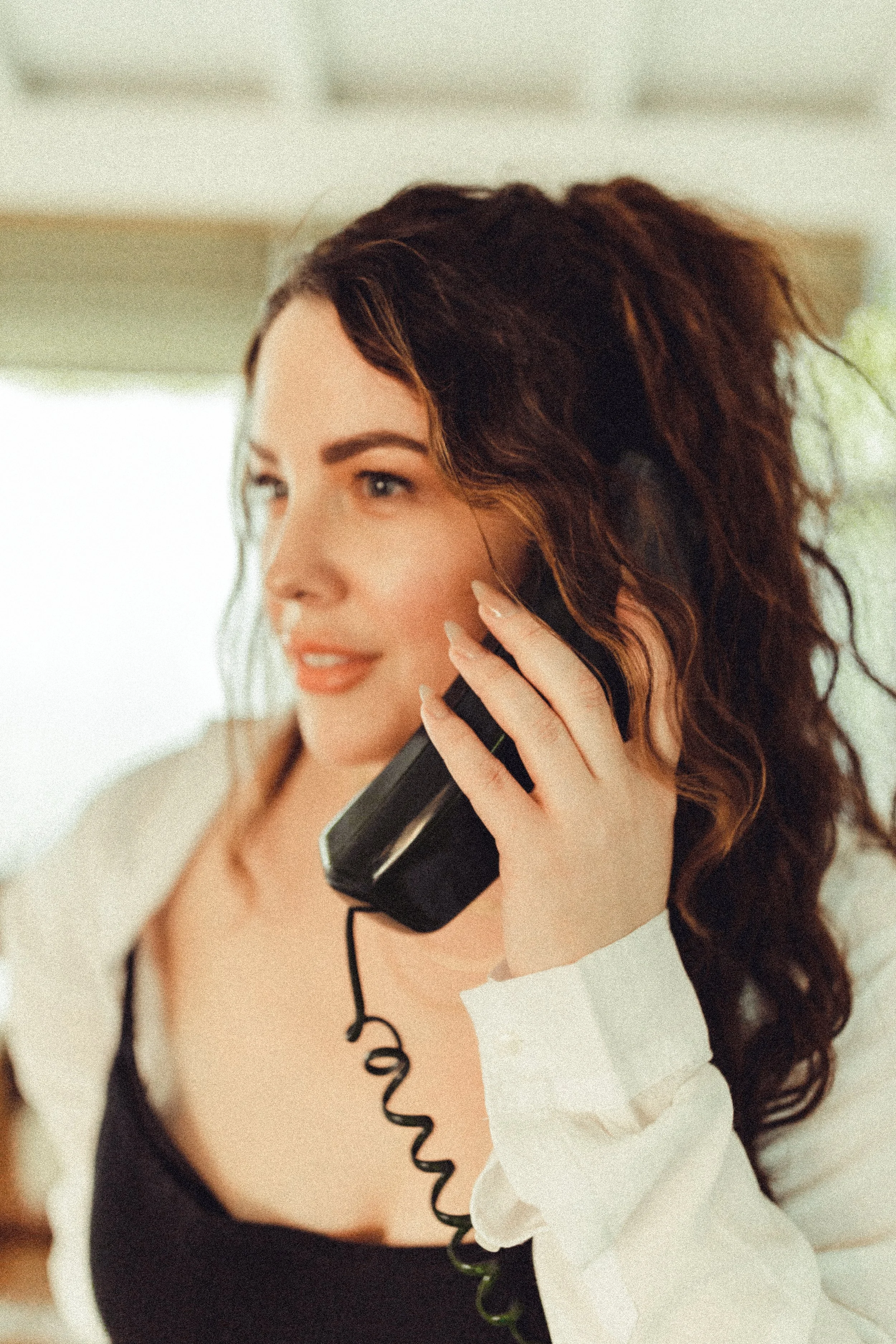Melissa Jaramillo, owner of Aloe Studio, styled in an effortless brunette curls updo for an editorial photoshoot for Aloe Studio.