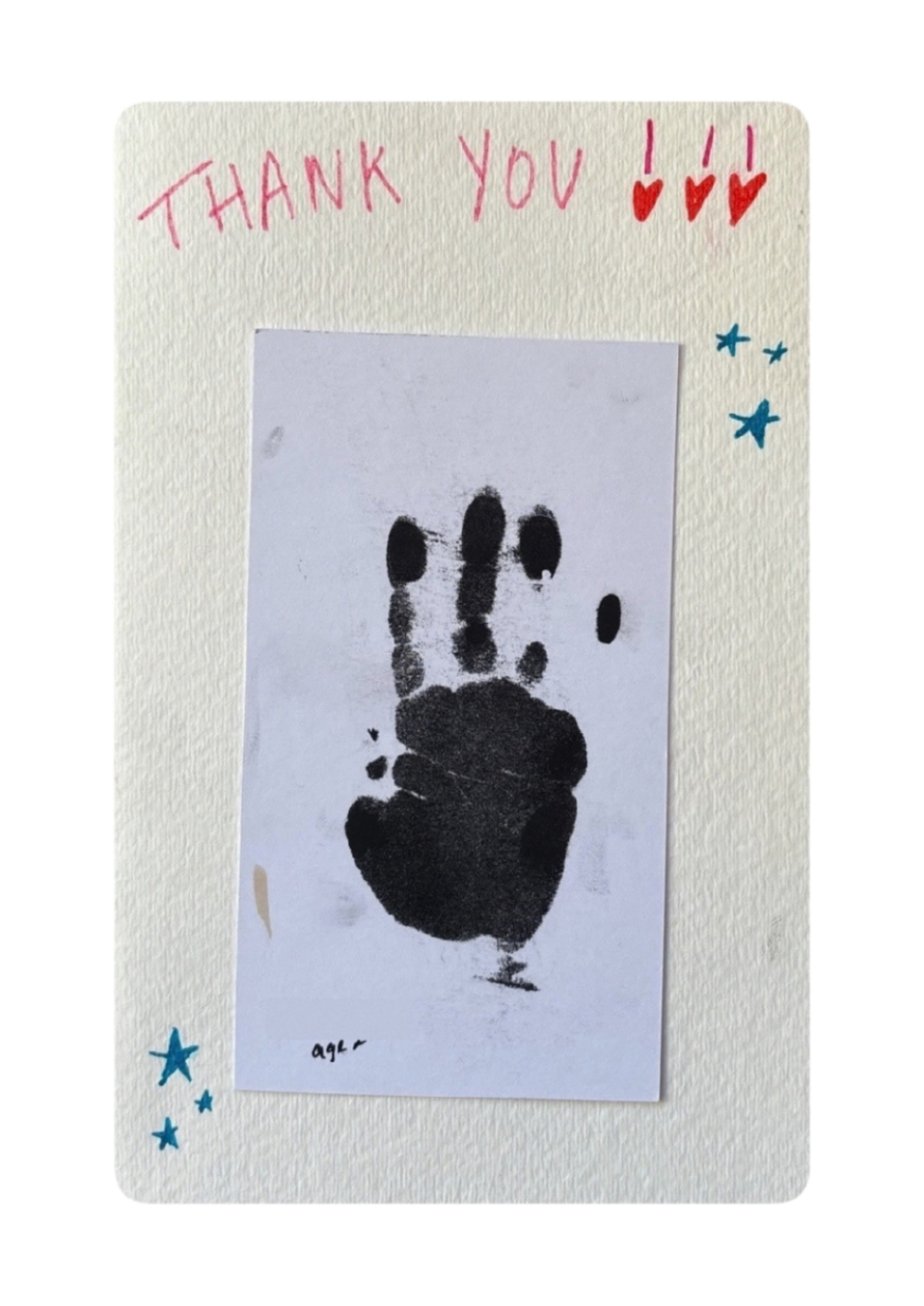 A thank you card with colorful handwritten text at the top, hearts and stars drawn around the edges, and a black handprint in the center on a white background.