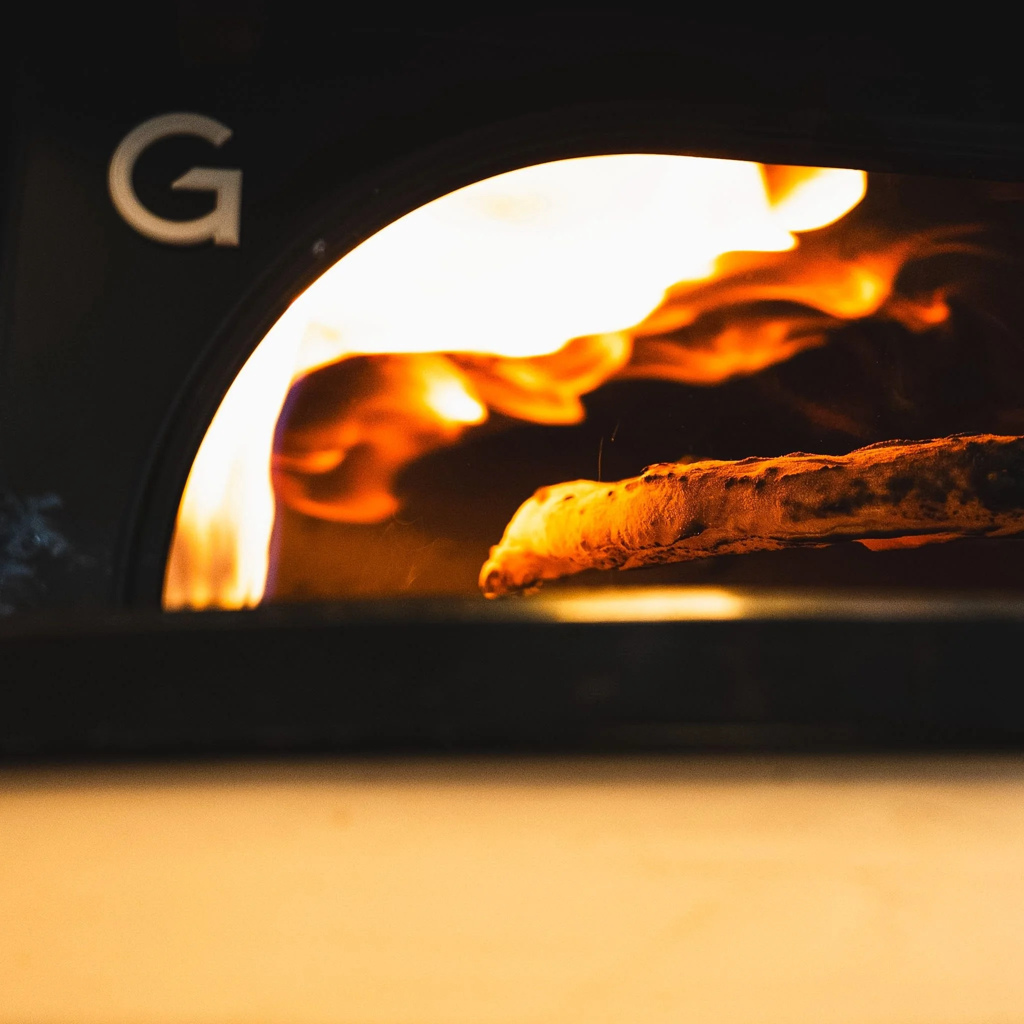 Close-up of a glowing fireplace with visible flames and logs.