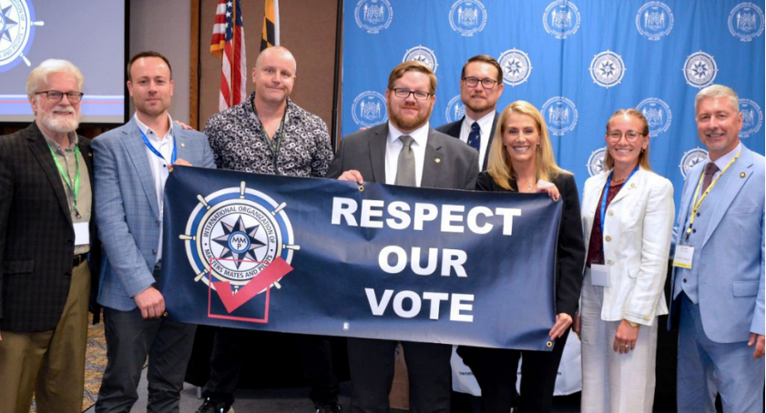 MM&P Officers and OSG Mate holding a “Respect Our Vote” banner at an organizational event with Sarah Nelson, International President of the Association of Flight Attendants-CWA, AFL–CIO.