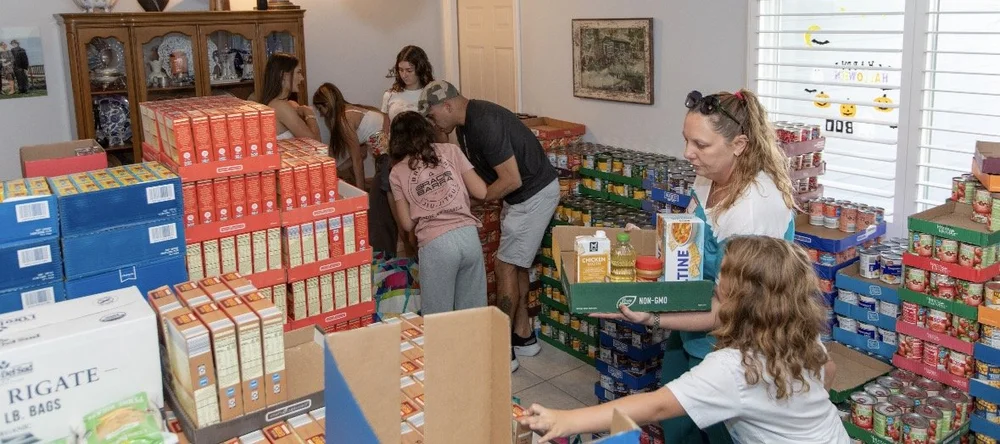 Volunteers packing Thanksgiving food bags together