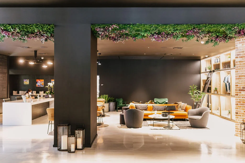 Foliage canopy cascading from the ceiling above a residents lounge