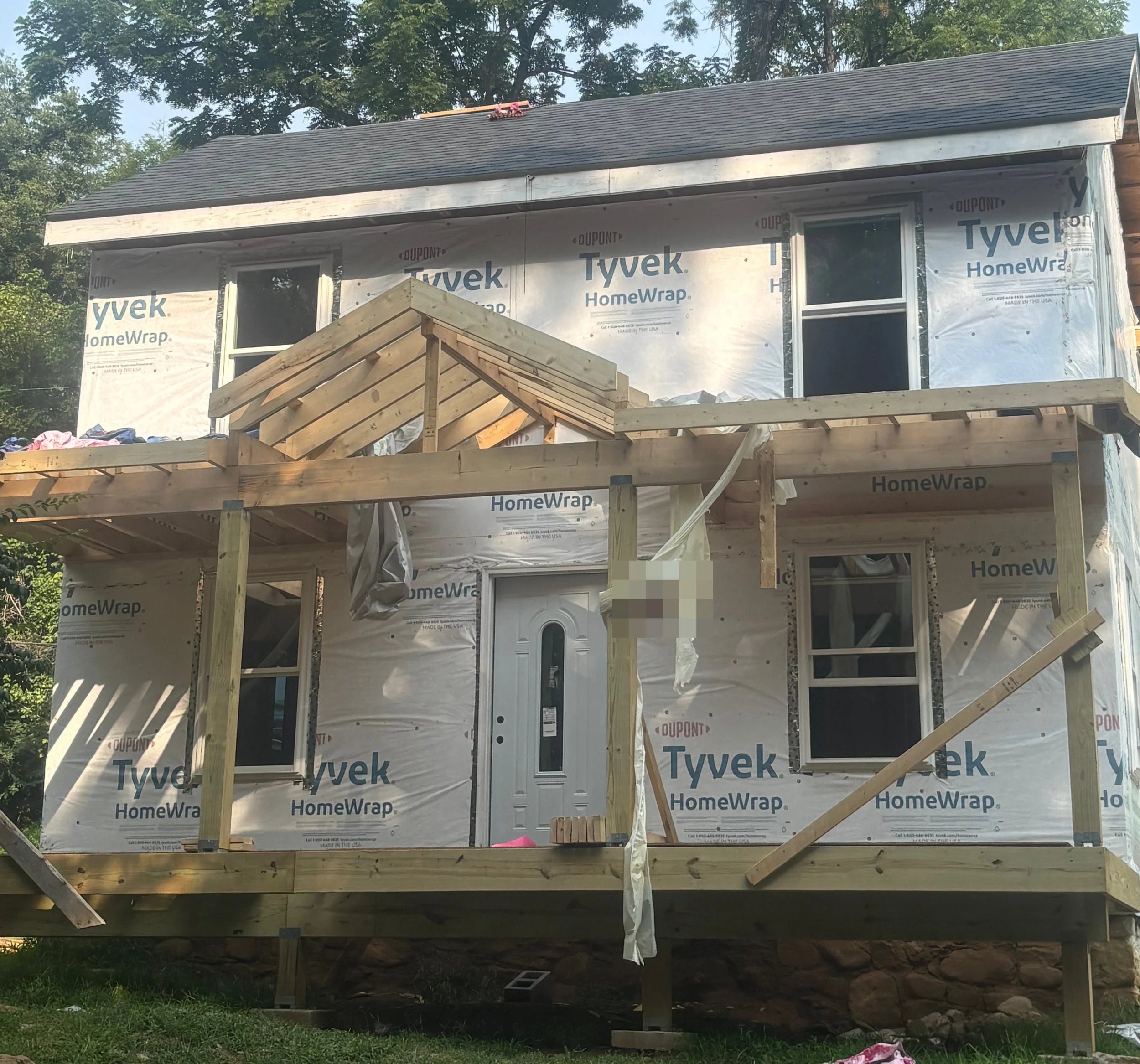 Exterior remodel with a new roof and porch, refreshing the curb appeal and protecting the home for the long haul.