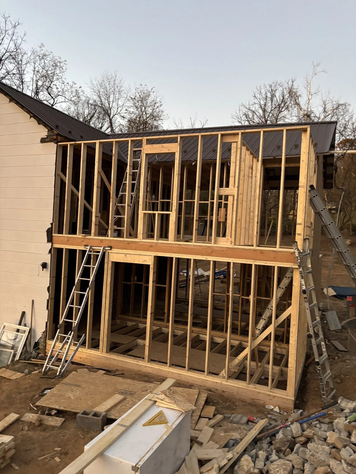 Two-story addition on a fully renovated house, adding generous new living space that ties cleanly into the original home.