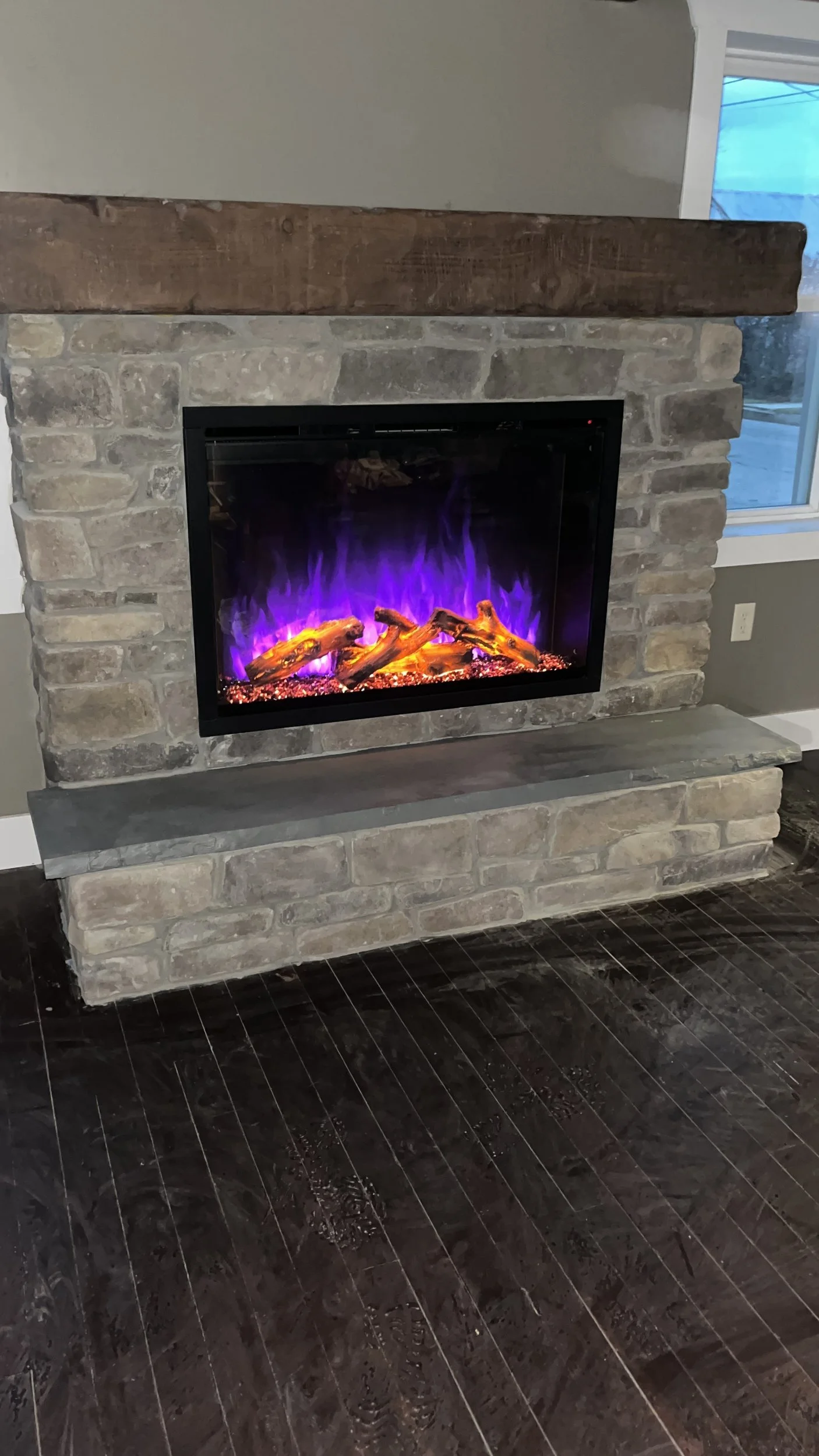Custom stone fireplace surround, a striking focal point that makes the whole room feel warmer.