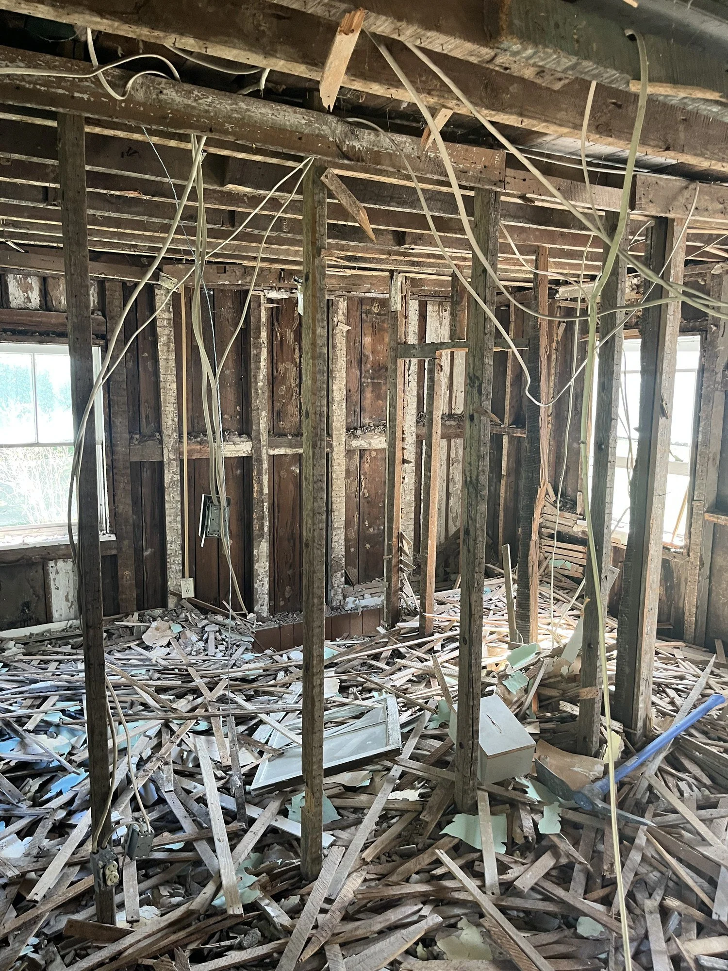 Interior gutted to the studs, clearing the way for new wiring, plumbing, insulation and a fresh layout.