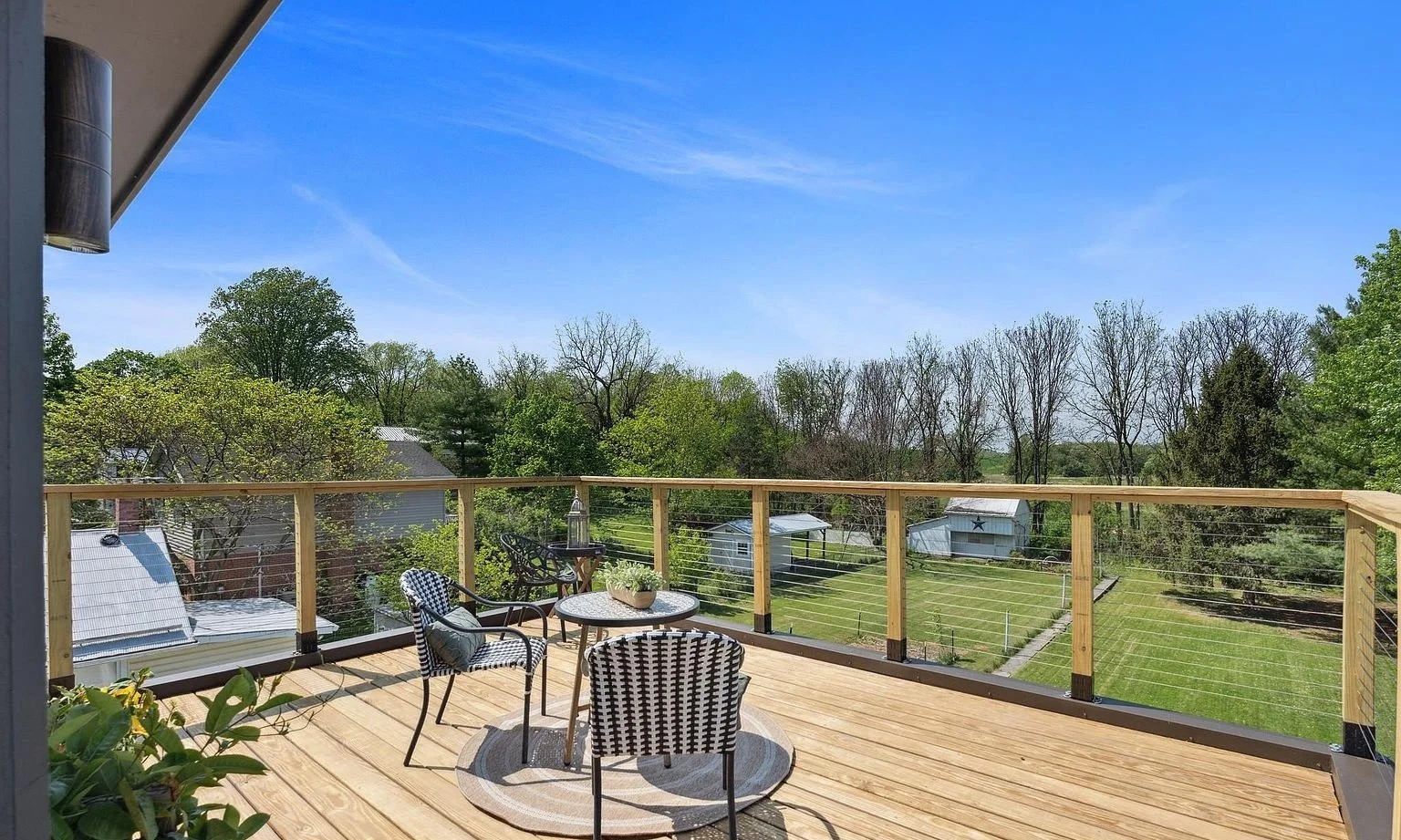 Elevated deck build with new wood decking and a cable-rail railing system overlooking the backyard.